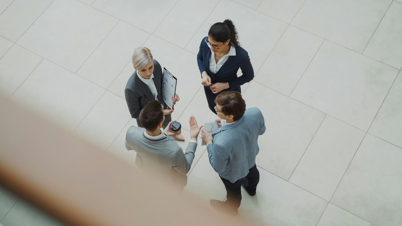 Colleagues talking in a modern office lobby